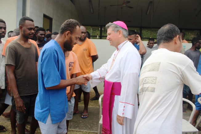 Nuncio shake hands with inmates